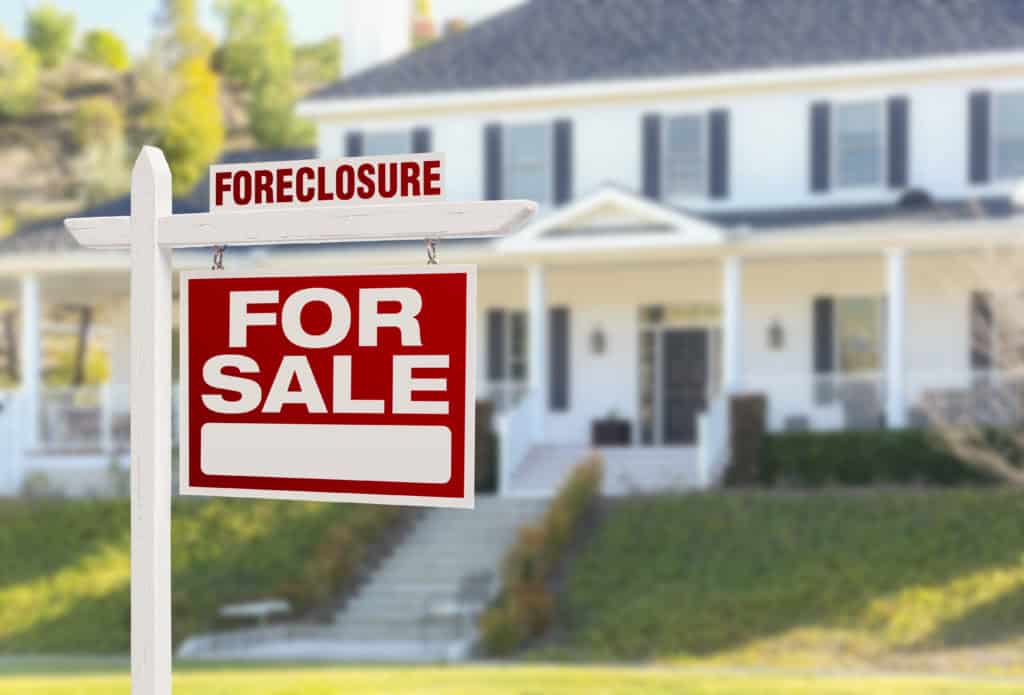 Foreclosure for sale sign in front of white house - Inland Empire foreclosure attorney