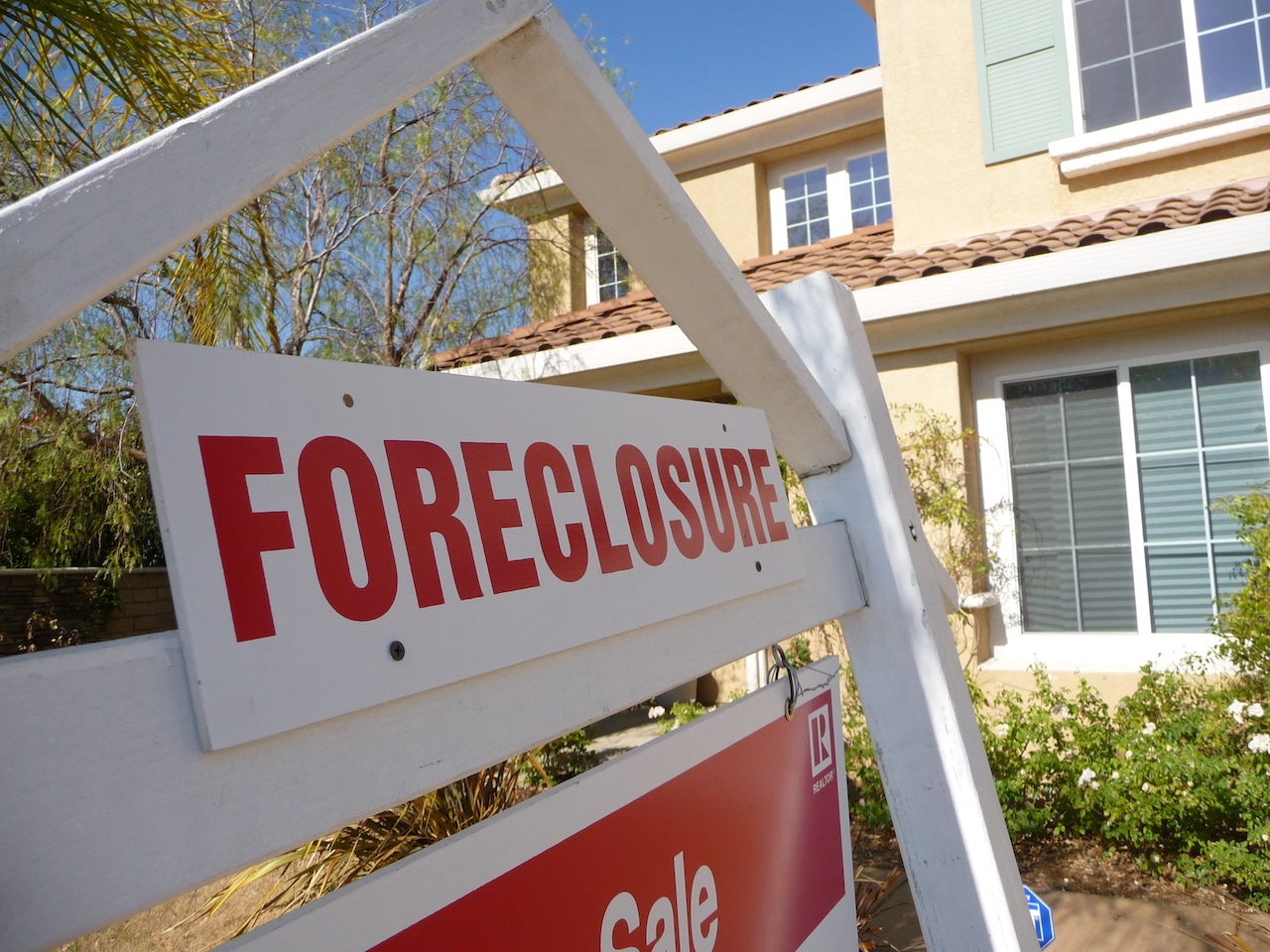 foreclosure sign in front of house
