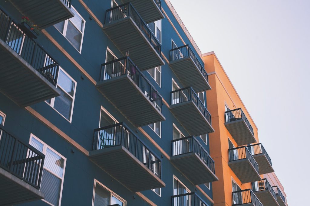 blue and orange apartment buildings with balconies affected by covid-19 real estate law