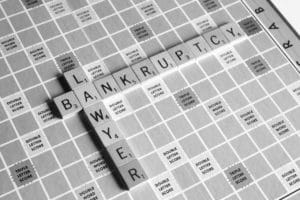 scrabble tiles spell out bankruptcy lawyer in black and white