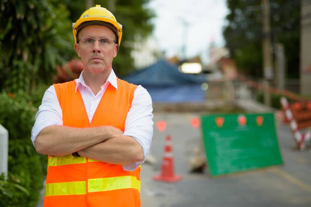 defective construction attorney - construction worker in front of cones