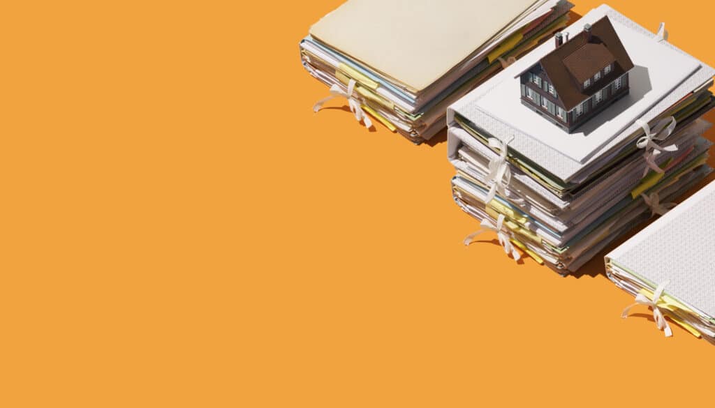 common types of real estate fraud - full binders on orange background