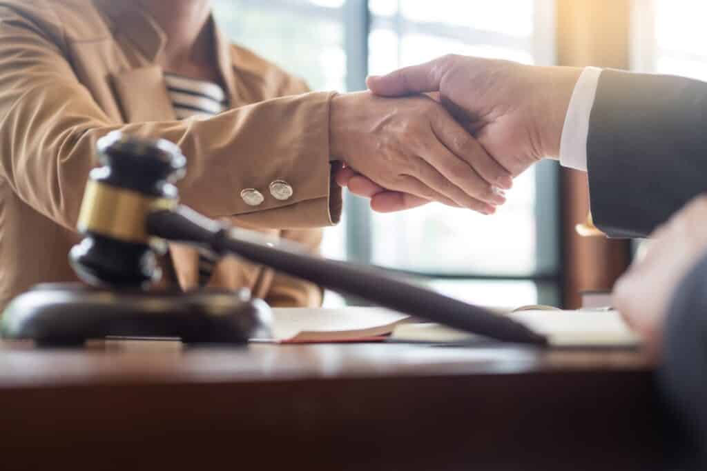 A lawyer shaking hands with a client