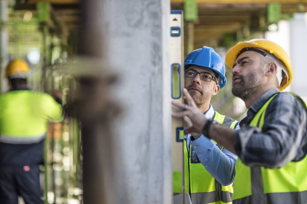 construction workers using spirit level