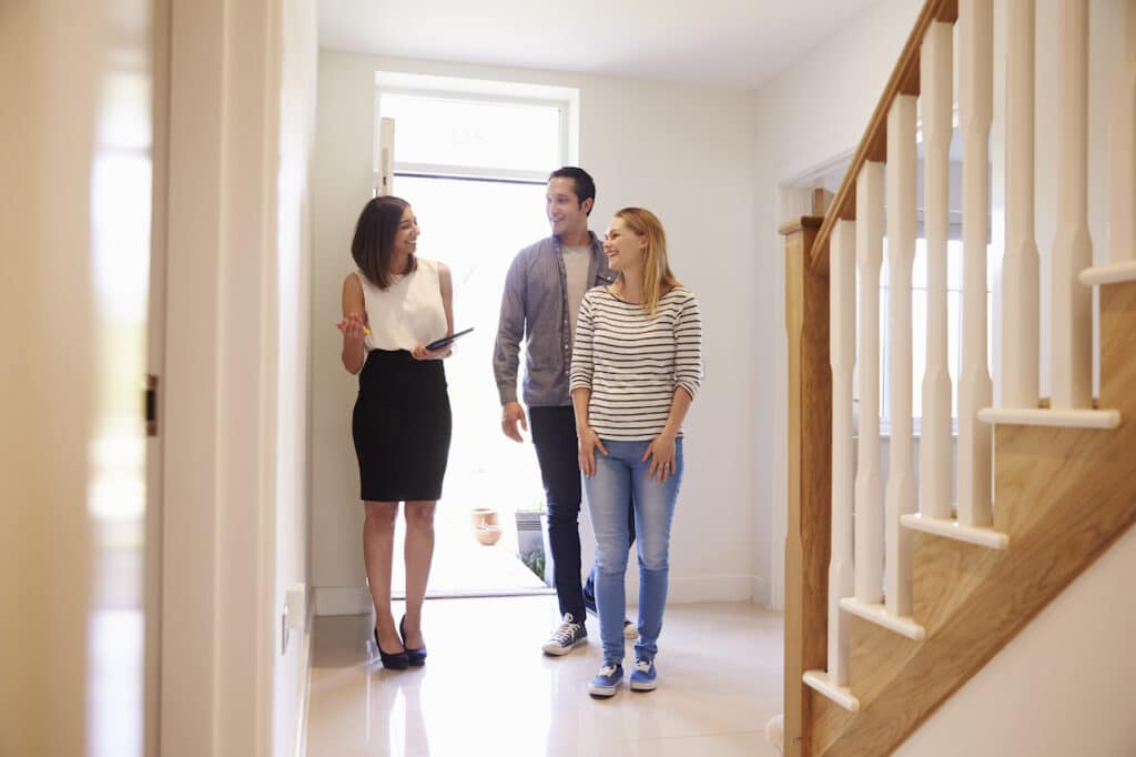 realtor showing couple around property